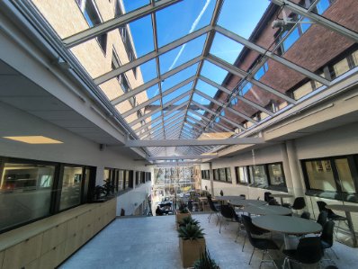 Innvendig glassatrium i næringsbygg med store glassflater